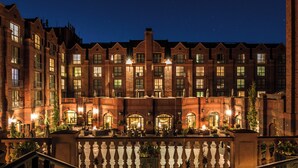 A large brick building with multiple windows and a central courtyard. - The St. Regis Aspen Resort (Aspen)