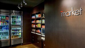 A vending area with refrigerated beverage dispensers and snack shelves. - Sonesta Select Raleigh Durham Airport Morrisville (Morrisville)