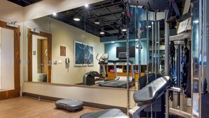 A gym with exercise equipment, a mirror, and a wooden floor. - Best Western Plus Bayside Inn (San Diego)