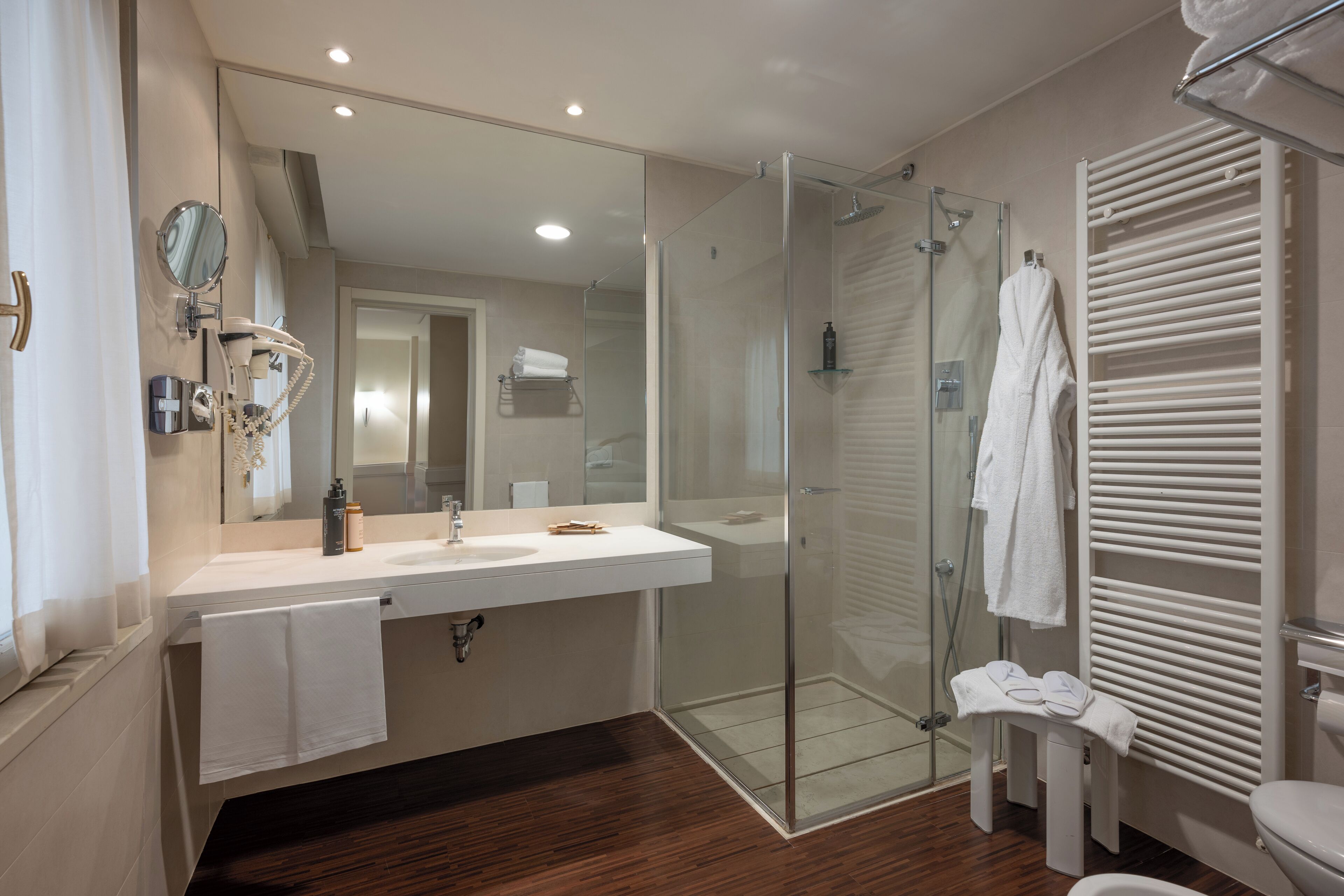 deluxe room | bathroom | eco-friendly toiletries, hair dryer, bidet, towels
