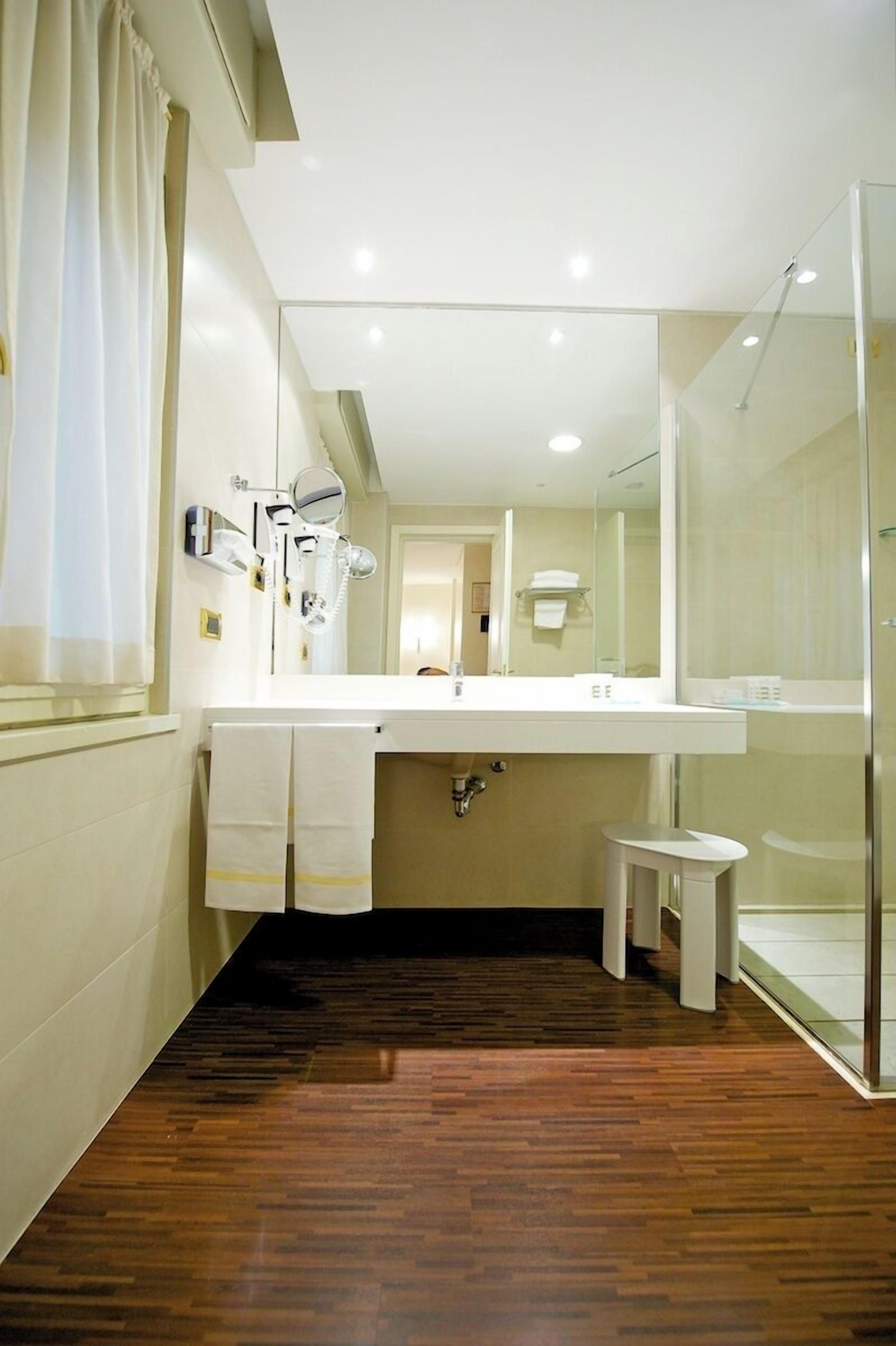 deluxe room | bathroom | eco-friendly toiletries, hair dryer, bidet, towels