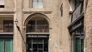 A hotel entrance with a sign reading "HOTEL STENDHAL".