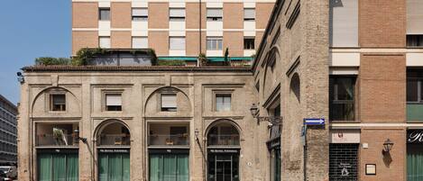 A historic building with a classic facade, featuring arched windows and a central entrance.