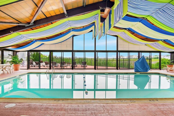 Relax by the pool with a view of the surrounding landscape through large windows.