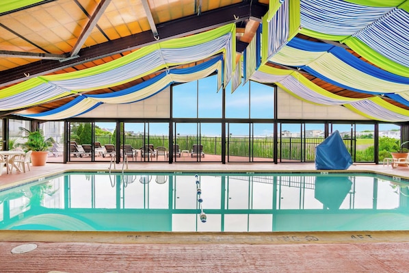 Relax by the pool with a view of the surrounding landscape through large windows.