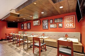 A restaurant interior with booths, tables, and chairs.
