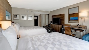 A hotel room with two beds, a desk, a chair, a TV, and a lamp. - Holiday Inn Mississauga Toronto West by IHG (Mississauga)