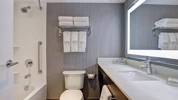 A modern bathroom with a bathtub, toilet, and sink.