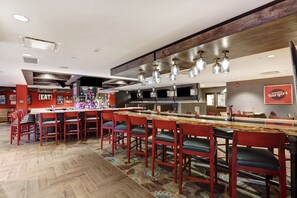 A restaurant with a bar area, multiple seating options, and a modern interior design. - Holiday Inn Mississauga Toronto West by IHG (Mississauga)