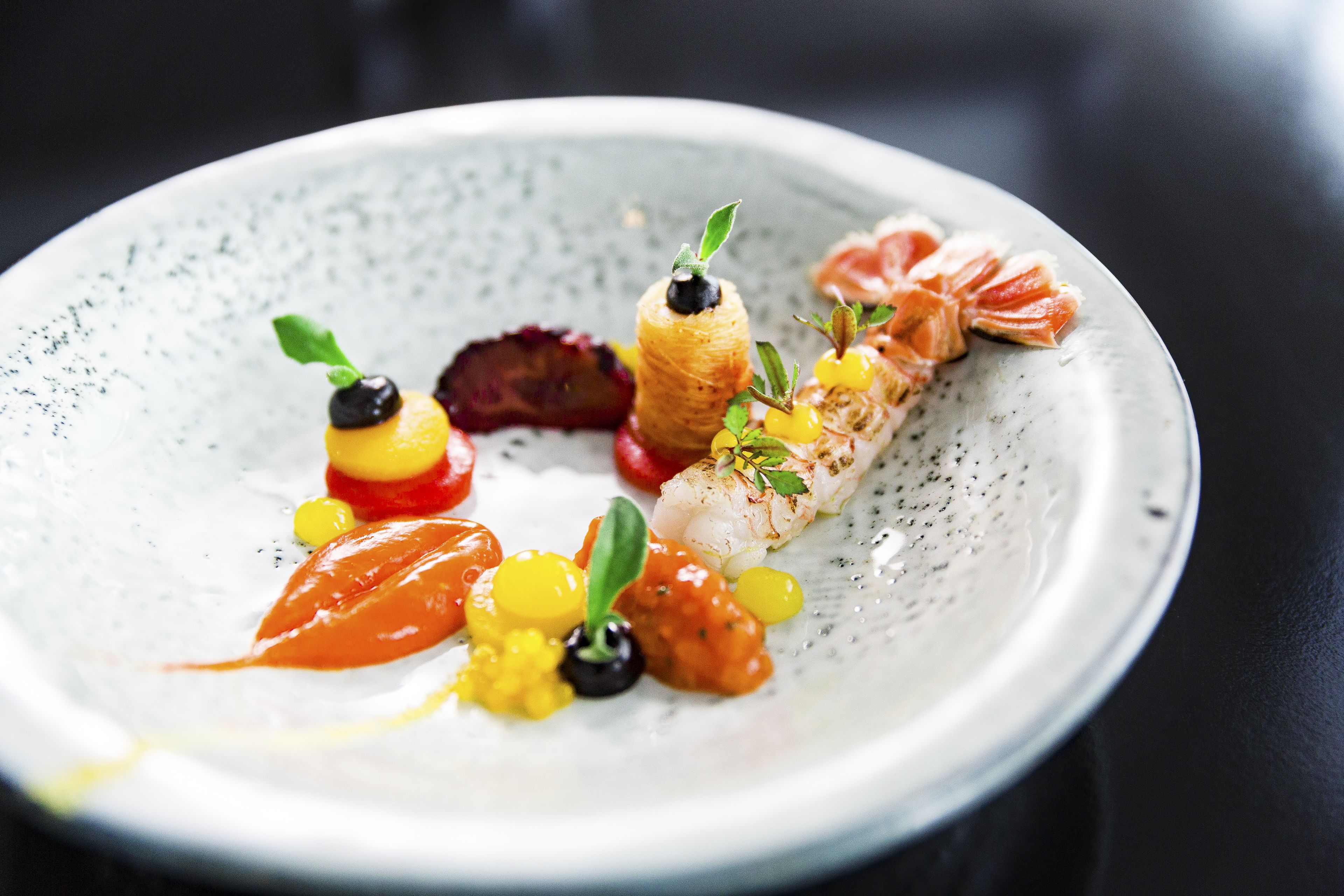 A plate of food with various garnishes and sauces.