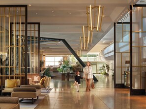 A spacious lobby with modern furniture, a staircase, and a large window providing natural light. - InterContinental Berlin by IHG (Berlin)