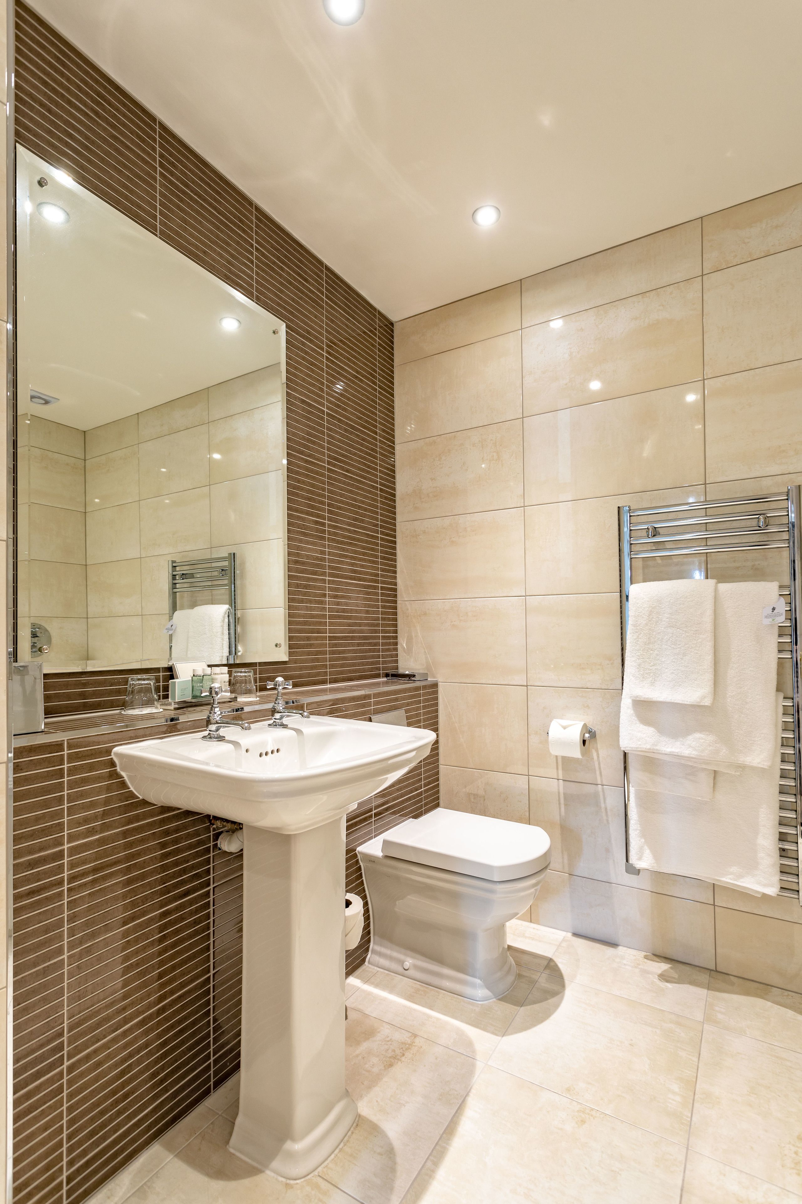 deluxe suite | bathroom | eco-friendly toiletries, hair dryer, towels