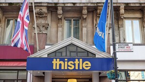A building with a sign reading "Whitcomb Street WC2" and a blue sign with "thistle" on it. - Thistle London Piccadilly (London)