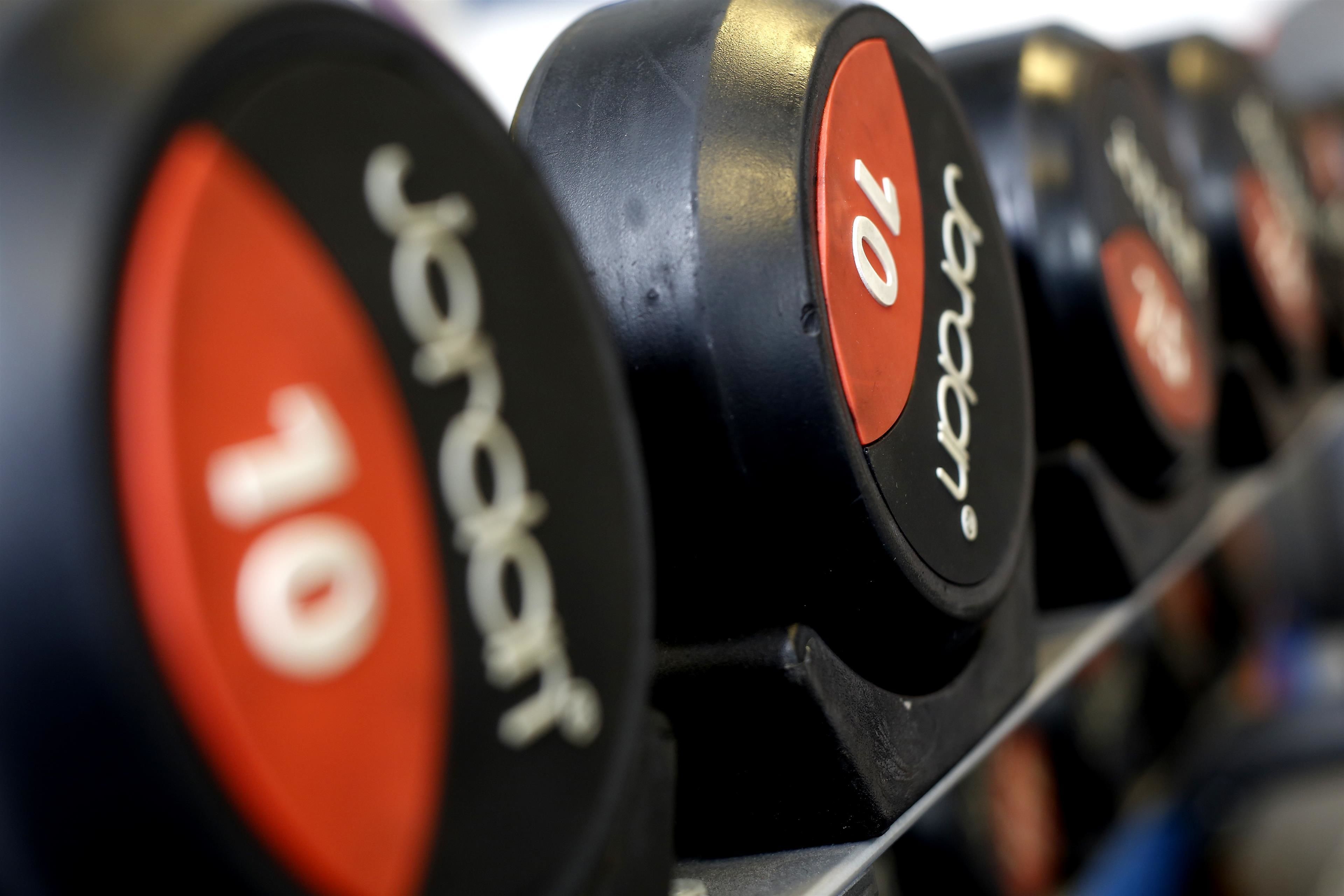A row of weight plates with numbers indicating their weight.