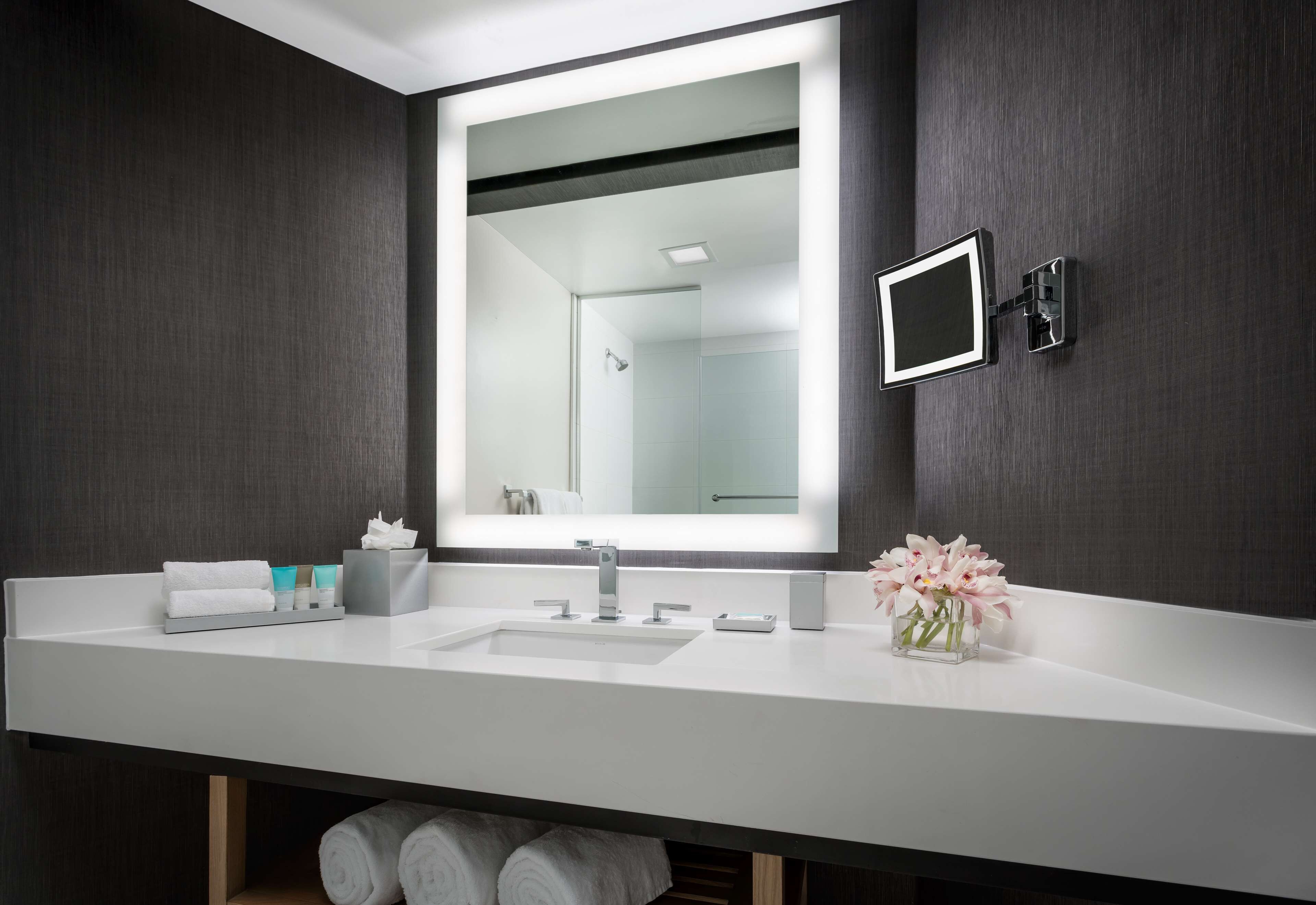 designer toiletries, hair dryer, towels