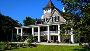 A large, historic building with a central tower, multiple windows, and a covered porch with columns. - North Charleston Marriott (North Charleston)