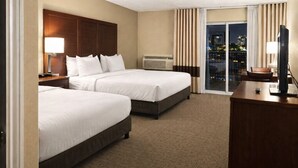 A hotel room with two beds, a desk with a TV, and a large window with curtains. - Comfort Inn  Farmington Hills - Detroit Northwest (Farmington Hills)