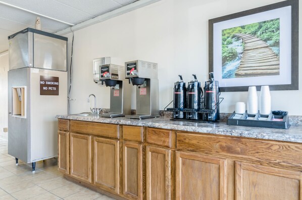 Enjoy a convenient coffee station with appliances and ample storage.
