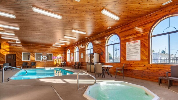 A wooden interior with a pool, hot tub, and seating area. - Comfort Inn Valentine (Valentine)