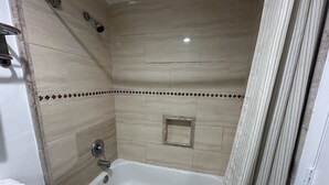 A bathroom with a bathtub, a shower, and a toilet.