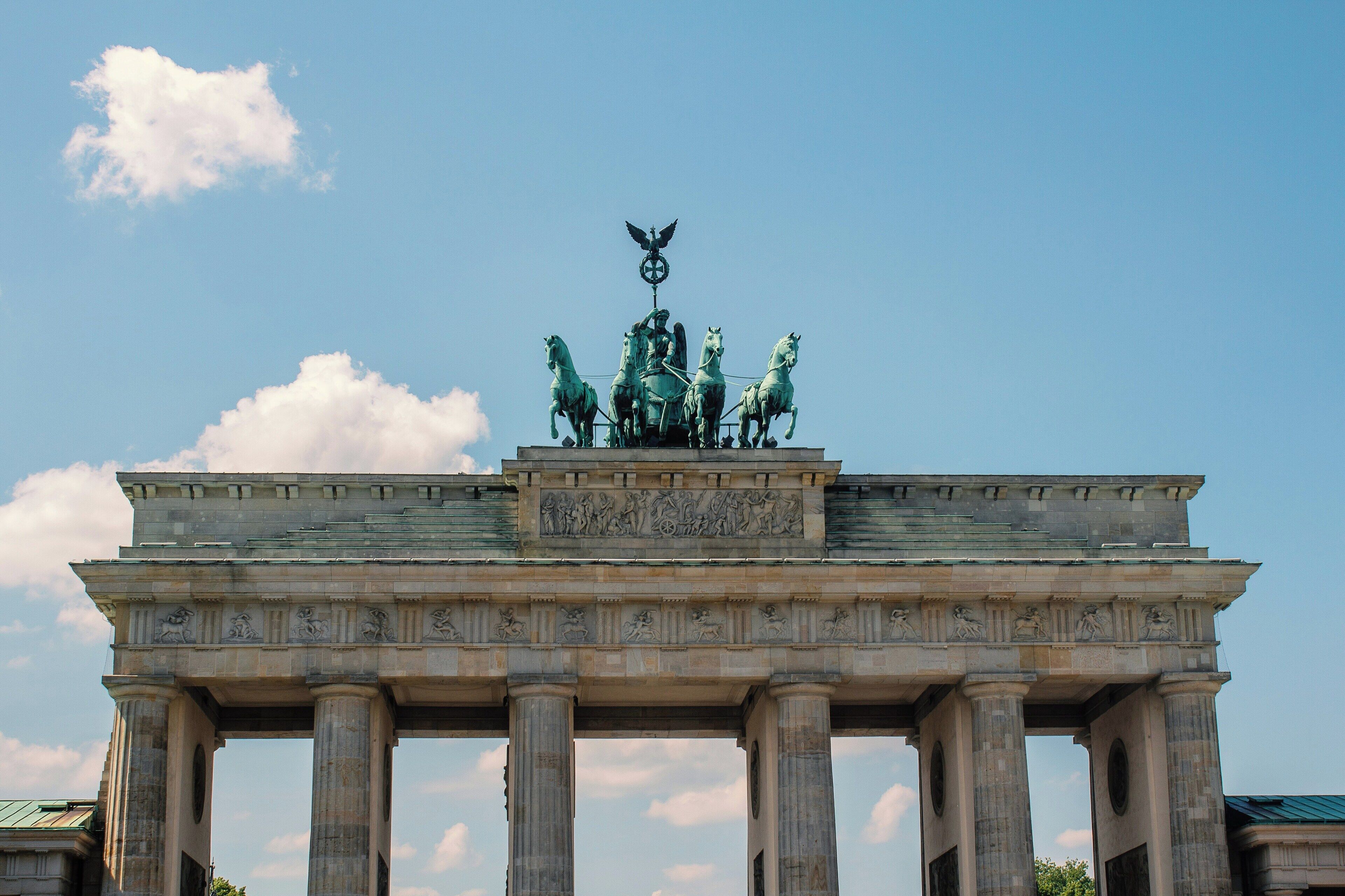 A large, historic monument with a central statue atop, surrounded by columns.