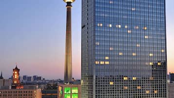 A modern hotel with a prominent 'Park Inn' sign, a tall tower, and a glass facade reflecting the cityscape.