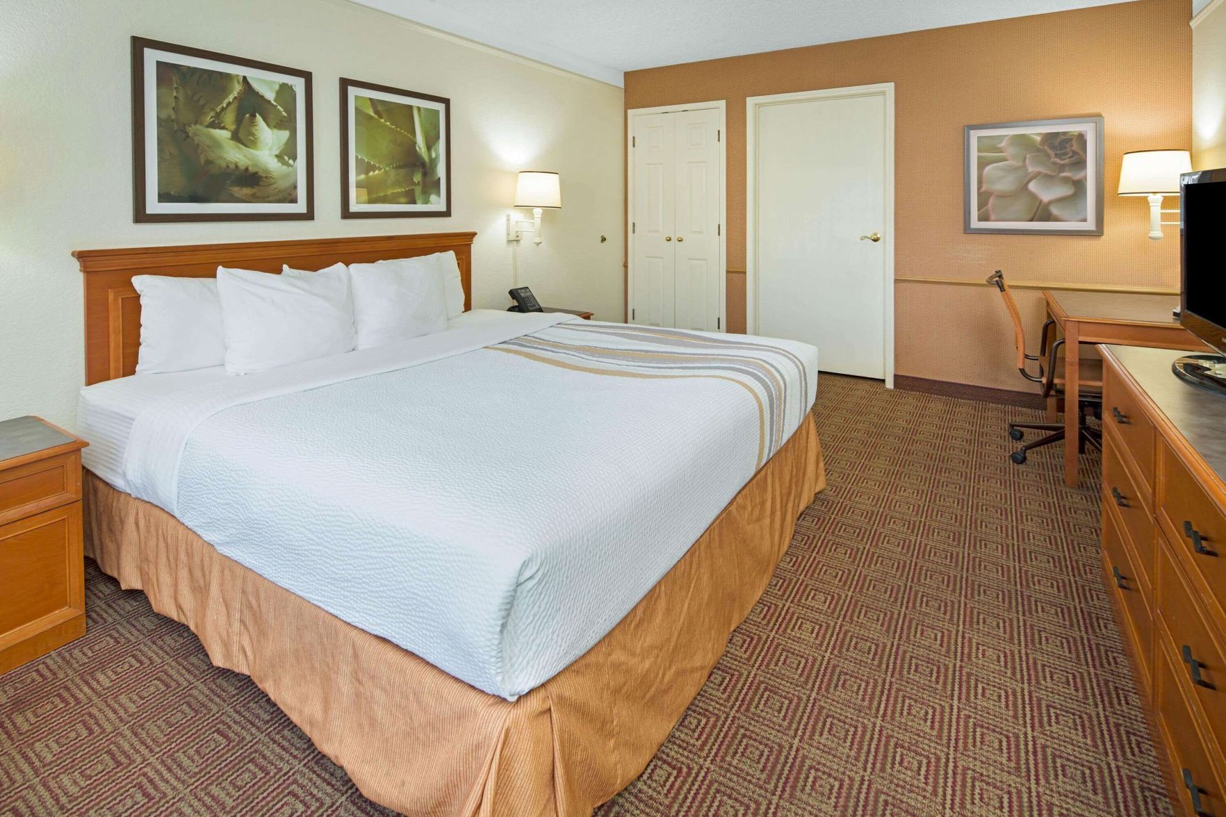Premium bedding, desk, laptop workspace, iron/ironing board