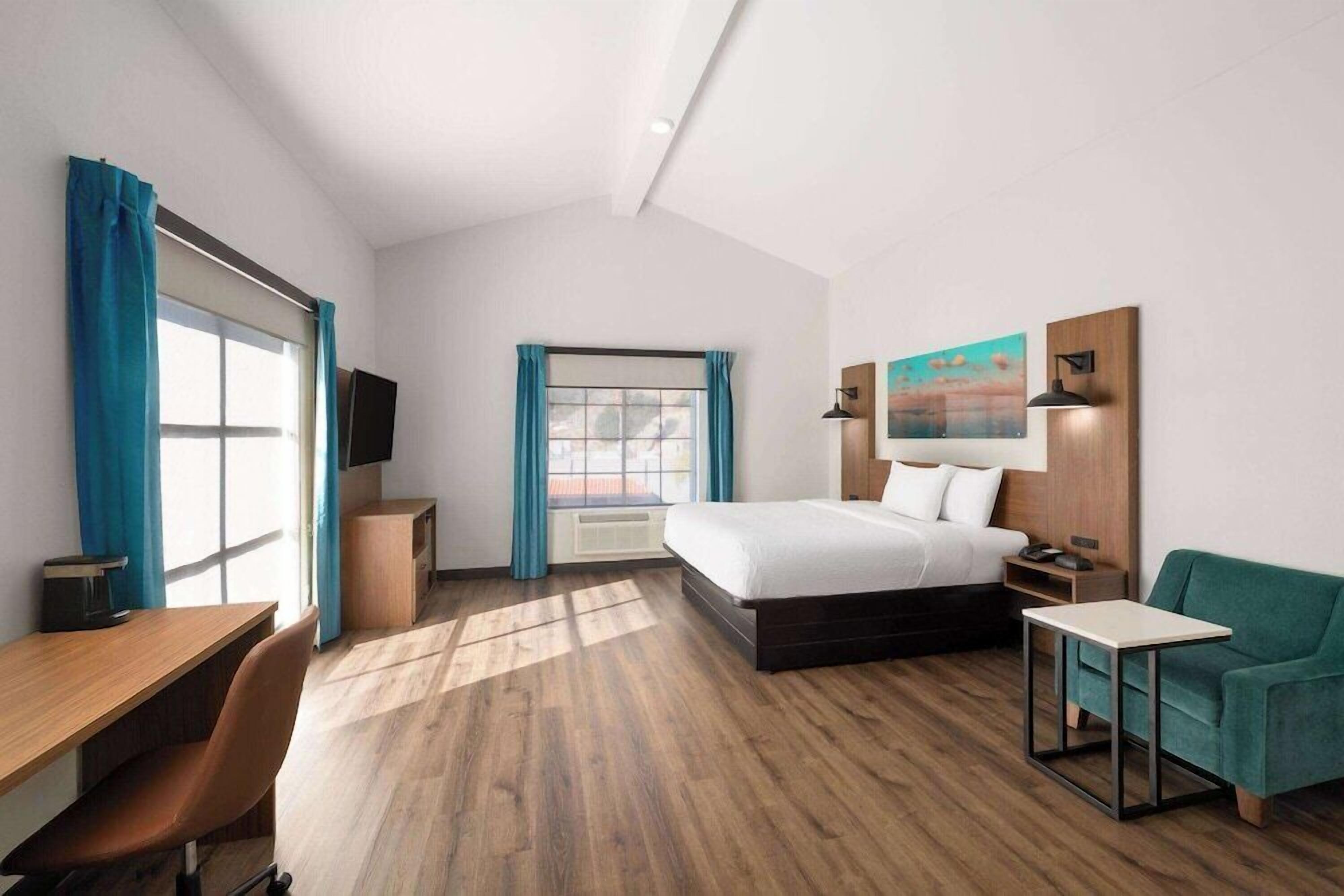 Premium bedding, desk, laptop workspace, iron/ironing board