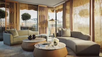 A modern living room with a sofa set, two round coffee tables, and a floor lamp.