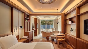 A modern hotel room with a large bed, a sitting area with a table and chairs, a television, and a view of the outdoors. - The Berkeley, Maybourne  (London)