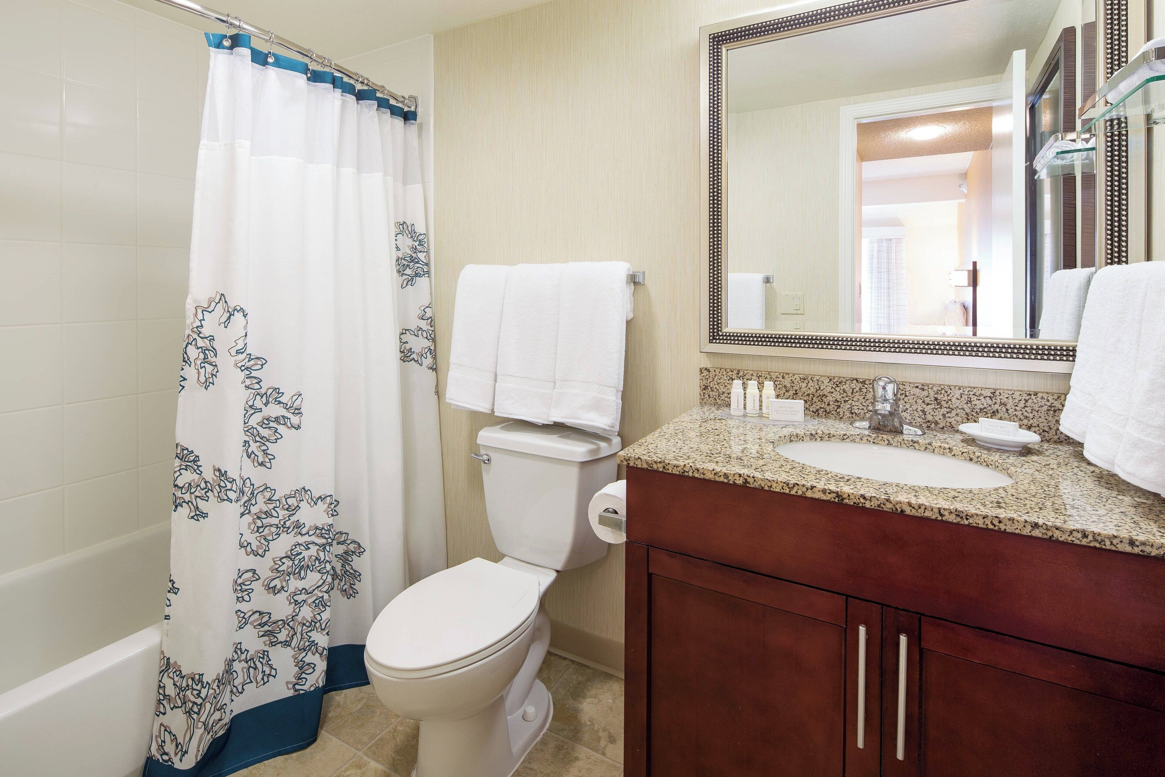 combined shower/bathtub, designer toiletries, hair dryer, towels