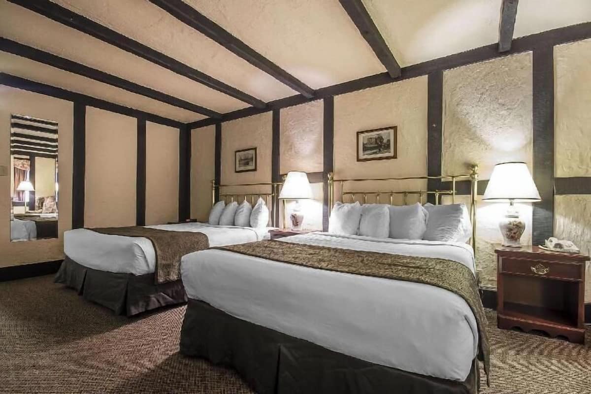 Desk, iron/ironing board, bed sheets, alarm clocks
