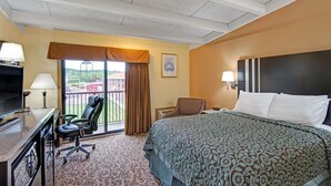 A hotel room with a bed, desk, chair, and a view of the outdoors. - Days Inn by Wyndham Washington Pennsylvania (Washington)