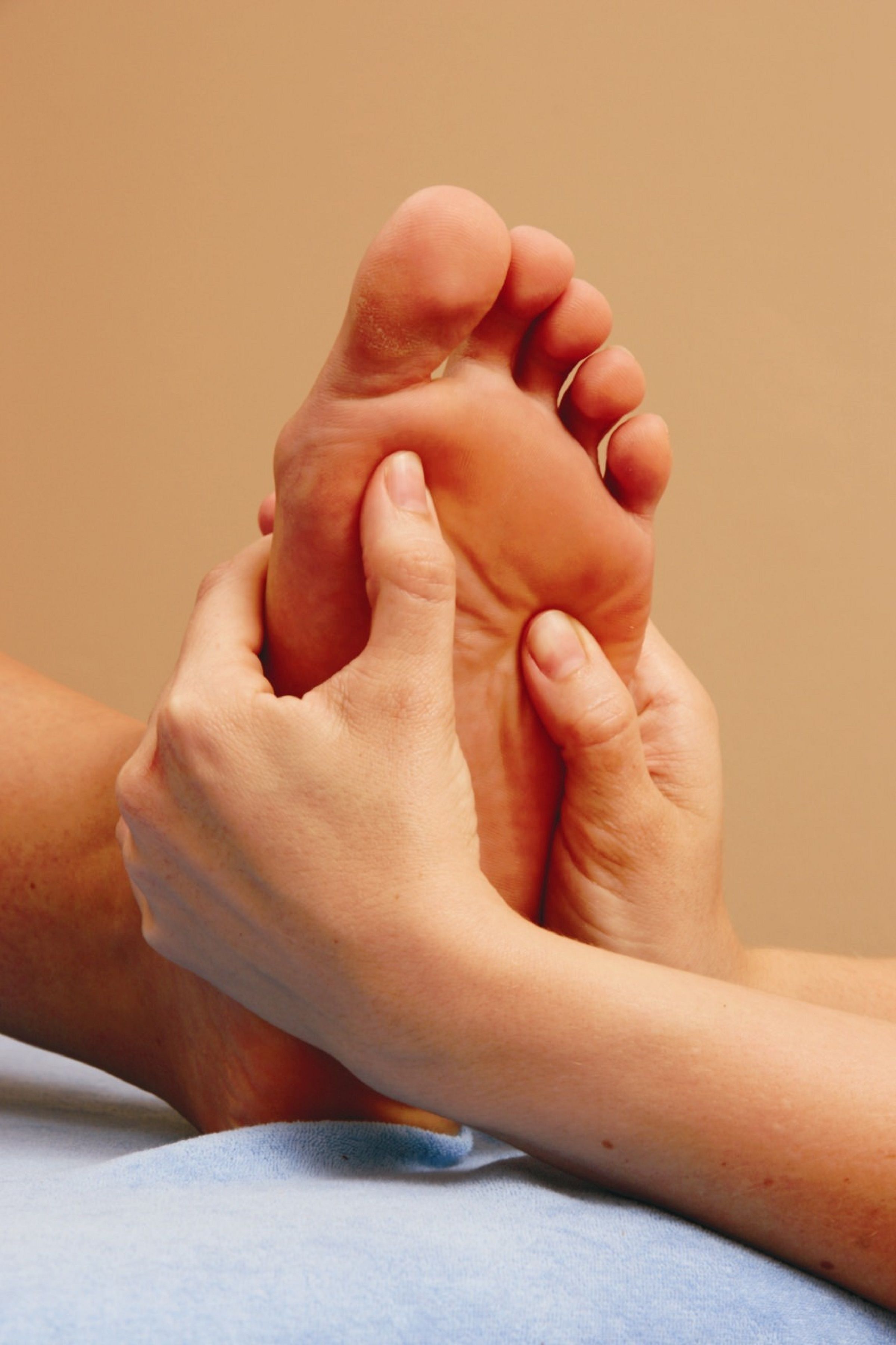 A close-up of a foot being massaged.