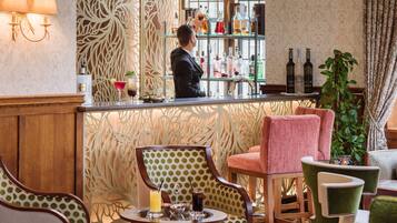 A bar area with a bartender, a variety of bottles, and a seating area with patterned chairs.