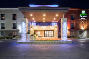 A hotel entrance with a covered area, stone pillars, and a sign for Holiday Inn Express & Suites. - Holiday Inn Express and Suites Albany Airport- Wolf Road by IHG (Albany)