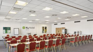 A conference room with red chairs and tables, a whiteboard, and a Coca-Cola refrigerator. - Best Western Hotel Bochum (Bochum)