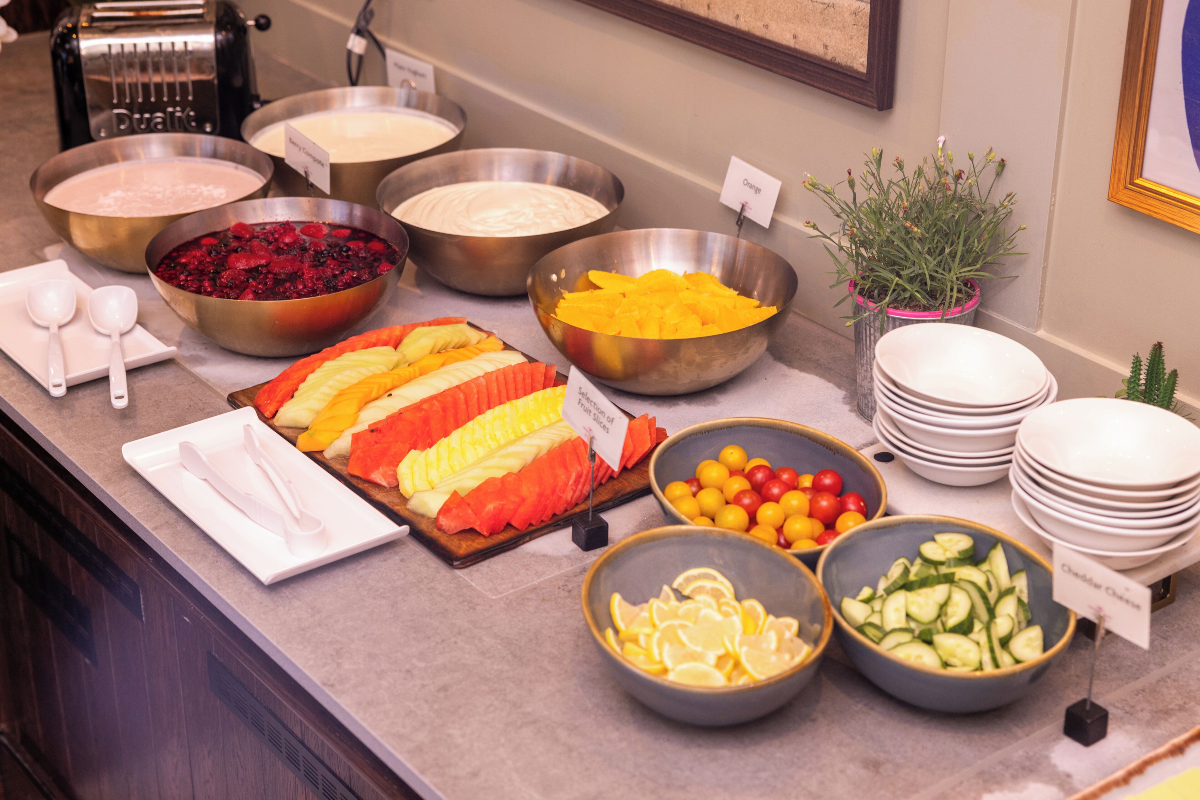 A buffet with various food items and utensils.
