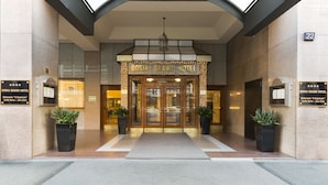 The entrance of Doria Grand Hotel with a double door entrance, potted plants, and a signboard. - Doria Grand Hotel (Milan)