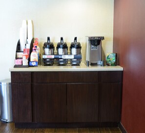 A kitchen area with a coffee machine, hot water dispenser, and a coffee maker. - Red Roof Inn PLUS+ University at Buffalo - Amherst (Buffalo)