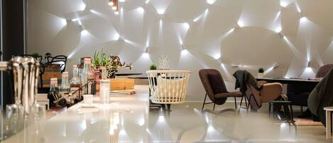 A modern interior with a geometric wall design, a polished floor, and contemporary furniture.