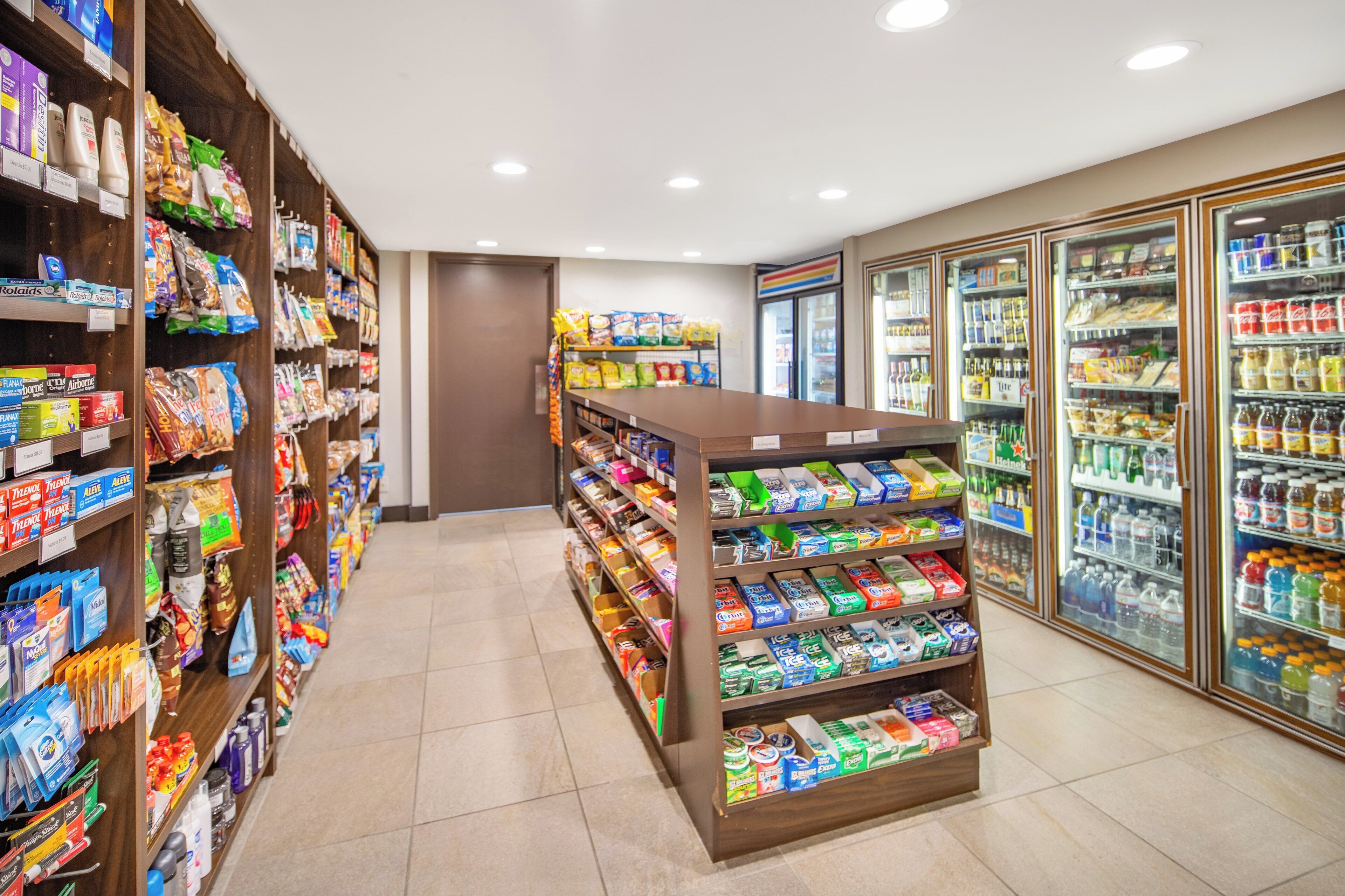 A grocery store aisle with shelves stocked with various products.
