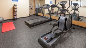 A fitness center with treadmills, elliptical machines, and a variety of exercise balls. - Days Inn by Wyndham Kent - Akron (Kent)