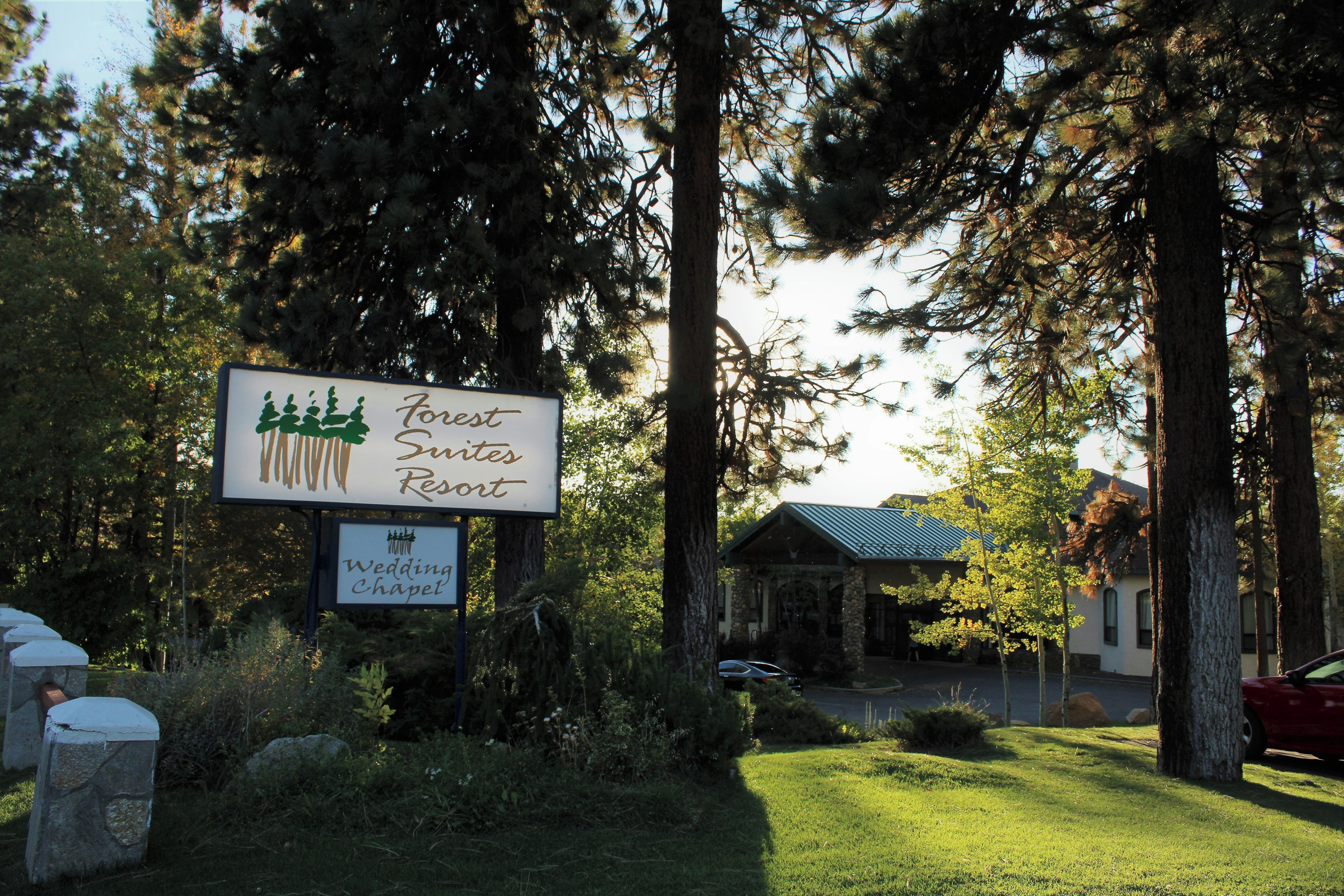 A sign for Forest Suites Resort with a Wedding Chapel.