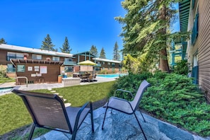 A poolside area with outdoor seating and a pool.