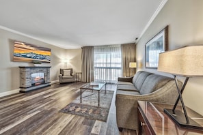 Deluxe Suite, 1 Bedroom | Living area | 60-inch flat-screen TV with cable channels, TV