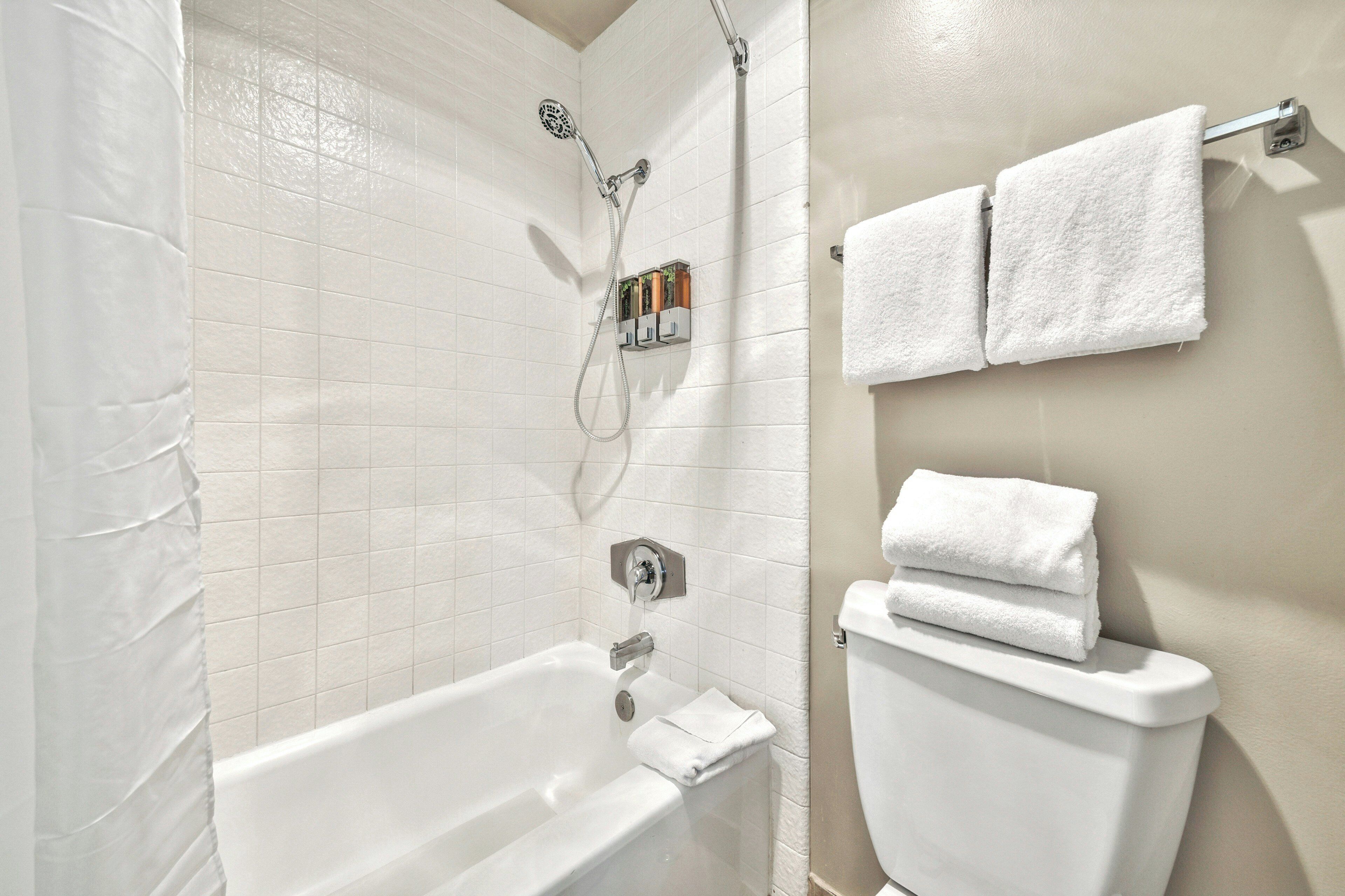 A bathroom with a bathtub, a shower, and a toilet.