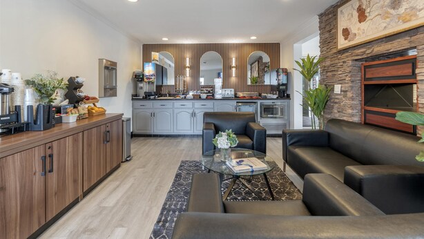 A modern kitchen with grey cabinets, a coffee machine, and a built-in oven. - Best Western Westminster Inn (Westminster)