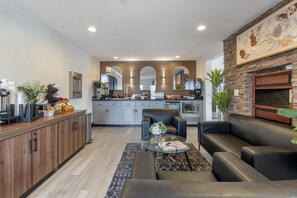 A modern kitchen with grey cabinets, a coffee machine, and a built-in oven. - Best Western Westminster Inn (Westminster)