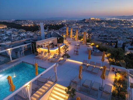 Seasonal outdoor pool, pool umbrellas, pool loungers. St. George Lycabettus Lifestyle Hotel